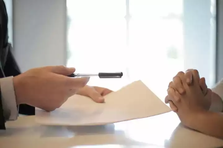 Hands holding paperwork