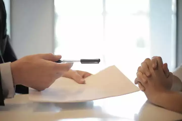 Hands holding paperwork