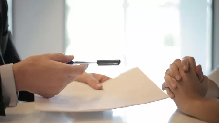 Hands holding paperwork